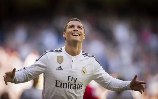 HD desktop wallpaper featuring Portuguese soccer player Cristiano Ronaldo in a white Real Madrid jersey, celebrating on the field with arms wide open.
