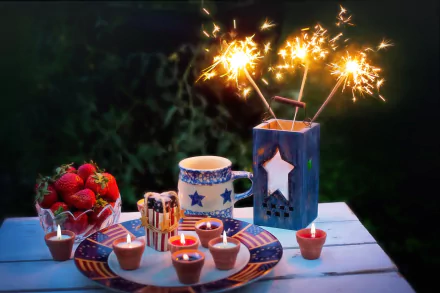 A festive 4th of July still life with sparklers, strawberries, star-decorated mugs, and candles, set as an HD PC desktop wallpaper celebrating Independence Day.