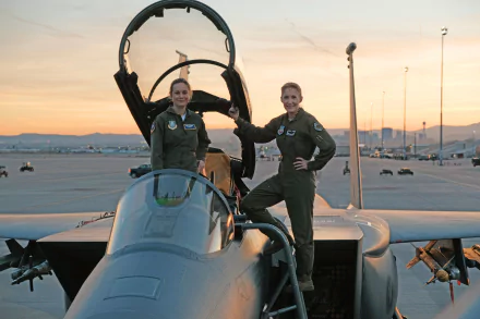 Carol Danvers and Brie Larson stand confidently by a fighter jet at sunset, featured in a 4K Ultra HD Captain Marvel movie wallpaper.