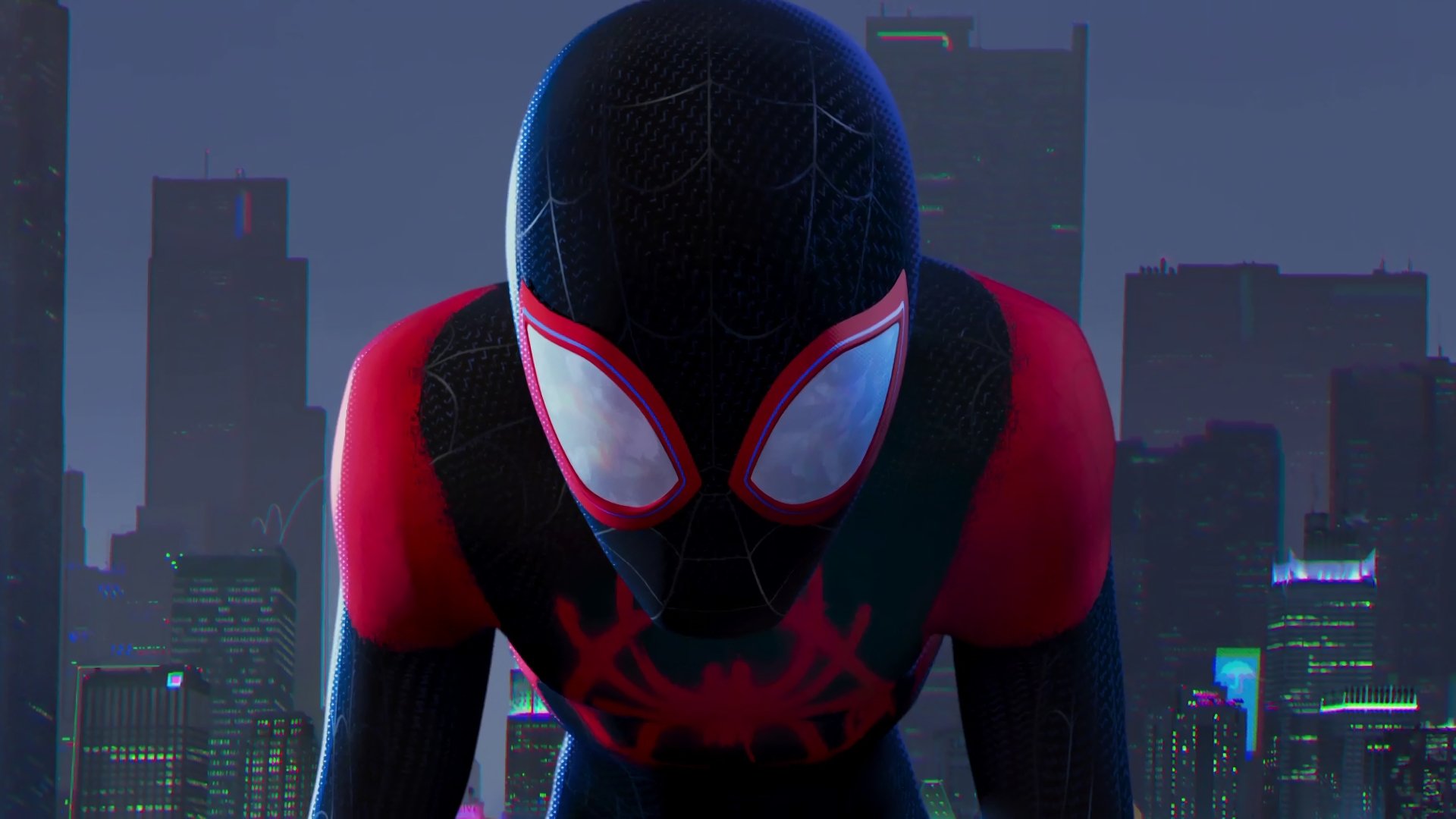 A 4K Ultra HD PC desktop wallpaper featuring Spider-Man from the movie Spider-Man: Into The Spider-Verse against a city skyline at night.