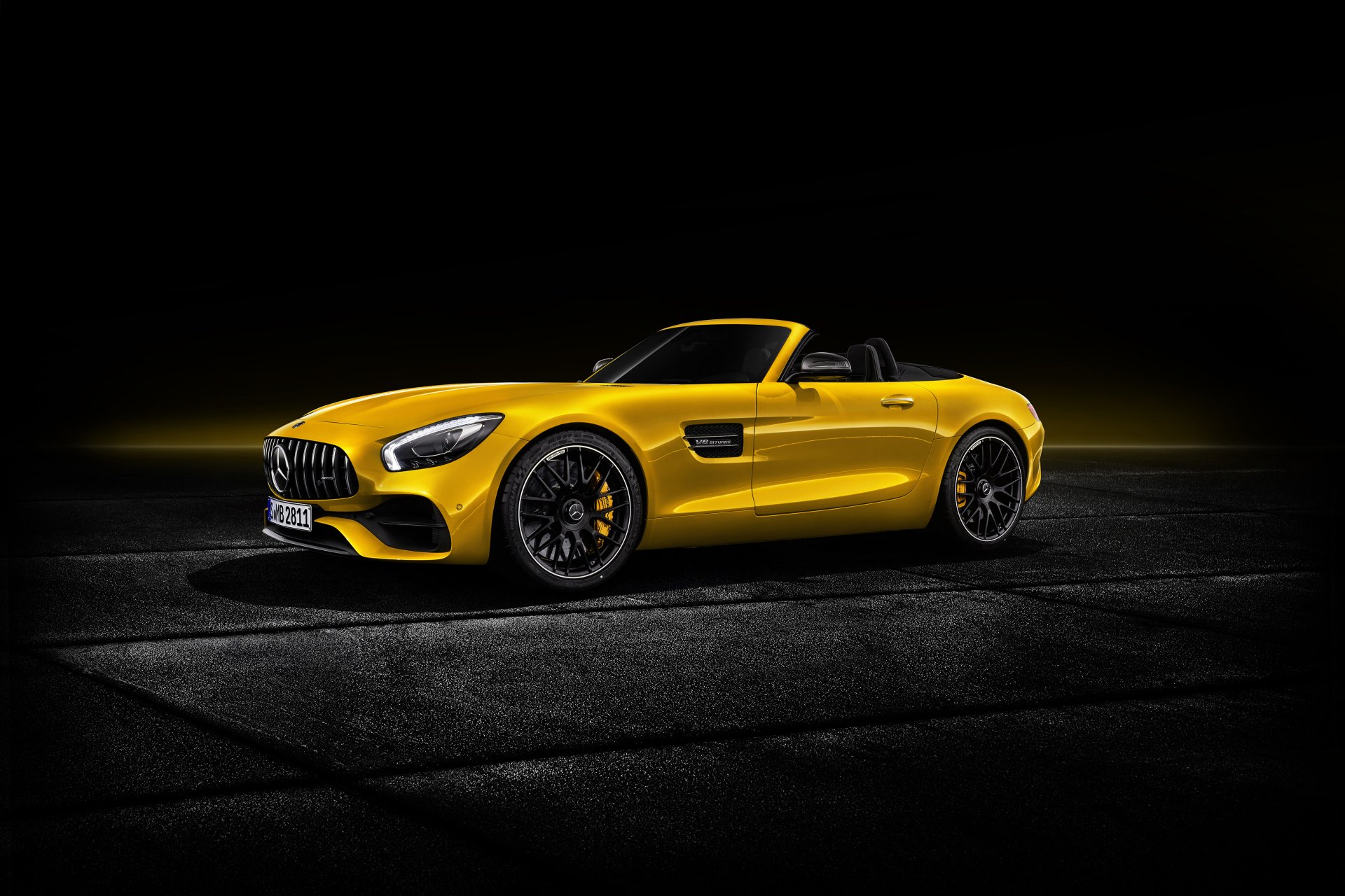 Yellow Mercedes-AMG GT S cabriolet supercar showcased in 4K Ultra HD, highlighting its sleek design and sporty elegance on a dark background.