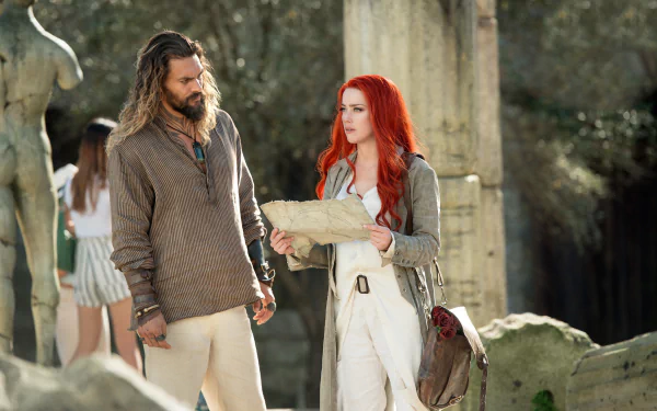 HD PC desktop wallpaper featuring Amber Heard and Jason Momoa in a scene from the Aquaman movie, showcasing their characters in a natural outdoor setting.
