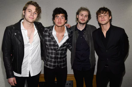 HD desktop wallpaper featuring the band 5 Seconds Of Summer posing together in stylish attire.