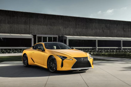 Yellow Lexus LC 500 Inspiration Concept grand tourer parked in front of a modern building, showcased as an HD PC desktop wallpaper and background.