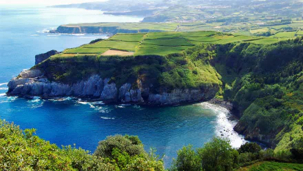 HD desktop wallpaper featuring the stunning coastline of the Azores, showcasing dramatic cliffs and lush greenery overlooking the azure ocean.
