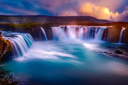 A stunning HD PC desktop wallpaper of Goðafoss waterfall surrounded by vibrant sky and natural landscape.