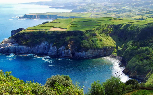 HD desktop wallpaper featuring the stunning coastline of the Azores, showcasing dramatic cliffs and lush greenery overlooking the azure ocean.