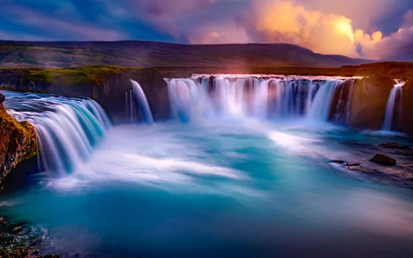 A stunning HD PC desktop wallpaper of Goðafoss waterfall surrounded by vibrant sky and natural landscape.