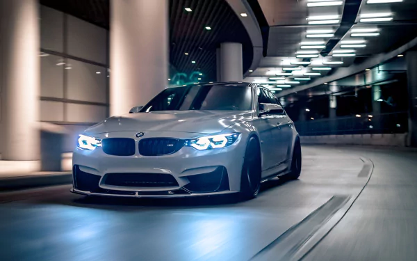 HD PC desktop wallpaper featuring a sleek BMW M3 driving through a modern, illuminated tunnel at night.
