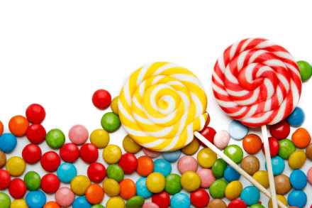 HD desktop wallpaper featuring colorful lollipops and an assortment of vibrant candy sweets scattered on a white background.