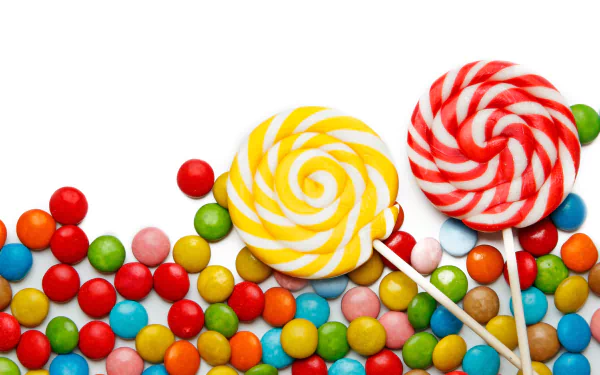 HD desktop wallpaper featuring colorful lollipops and an assortment of vibrant candy sweets scattered on a white background.