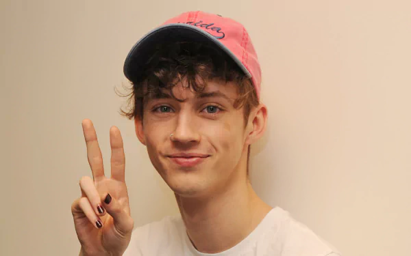 HD desktop wallpaper featuring a person posing with a peace sign, wearing a pink cap.