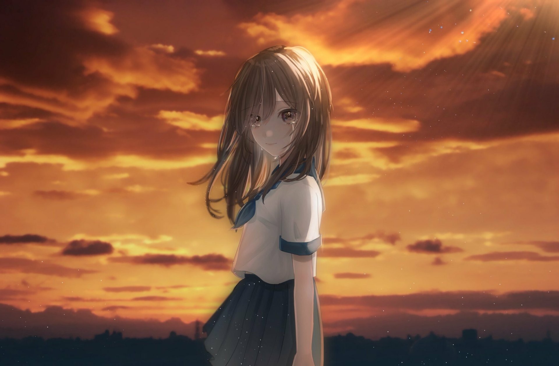 Anime-style girl with long brown hair and brown eyes smiles softly, tears shimmering as a vibrant orange sunset fills the sky, creating a serene HD desktop wallpaper scene.