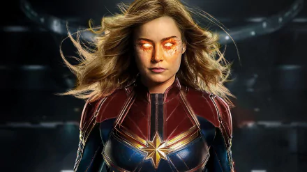 HD PC desktop wallpaper featuring Brie Larson as Captain Marvel with glowing eyes and detailed superhero costume in a dramatic cinematic setting.