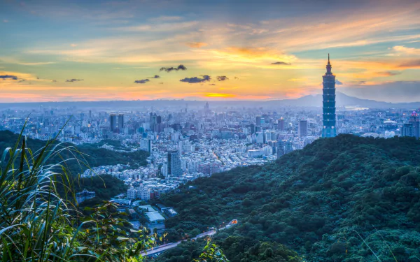 HD desktop wallpaper showcasing Taipei's cityscape featuring skyscrapers, including the iconic Taipei 101, against a sunset sky with lush greenery in the foreground.