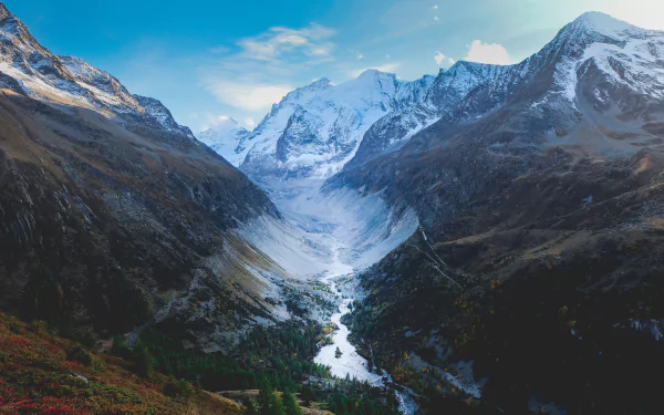 A breathtaking view of the Swiss mountains, showcasing majestic peaks and a serene valley. This 4K Ultra HD image captures the beauty of nature in Switzerland.