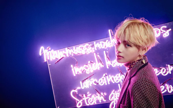 HD wallpaper of K-Pop singer V (Kim Tae-hyung) from BTS, posing against a backdrop of glowing neon text, radiating a cool and artistic vibe.