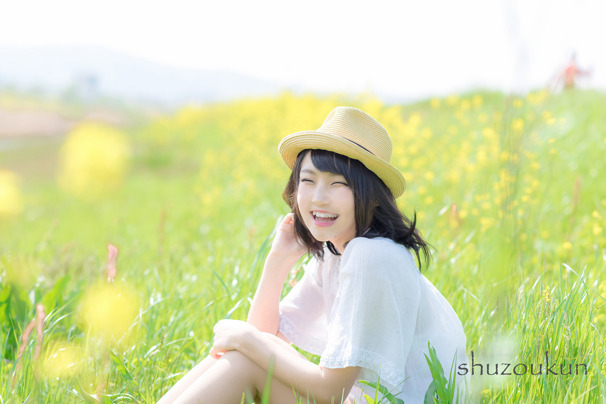 Woman sitting in a field of flowers laughing by shuzoukun