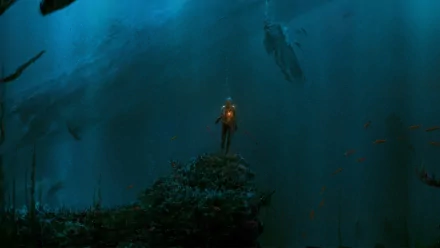 A captivating underwater scene featuring a lone diver illuminated against a dark, mysterious sea, surrounded by shadowy hints of a fantasy sea monster in a striking HD wallpaper.