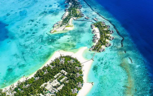 Aerial 4K Ultra HD image of tropical islands surrounded by vibrant turquoise waters, showcasing lush greenery and sandy beaches in stunning detail.