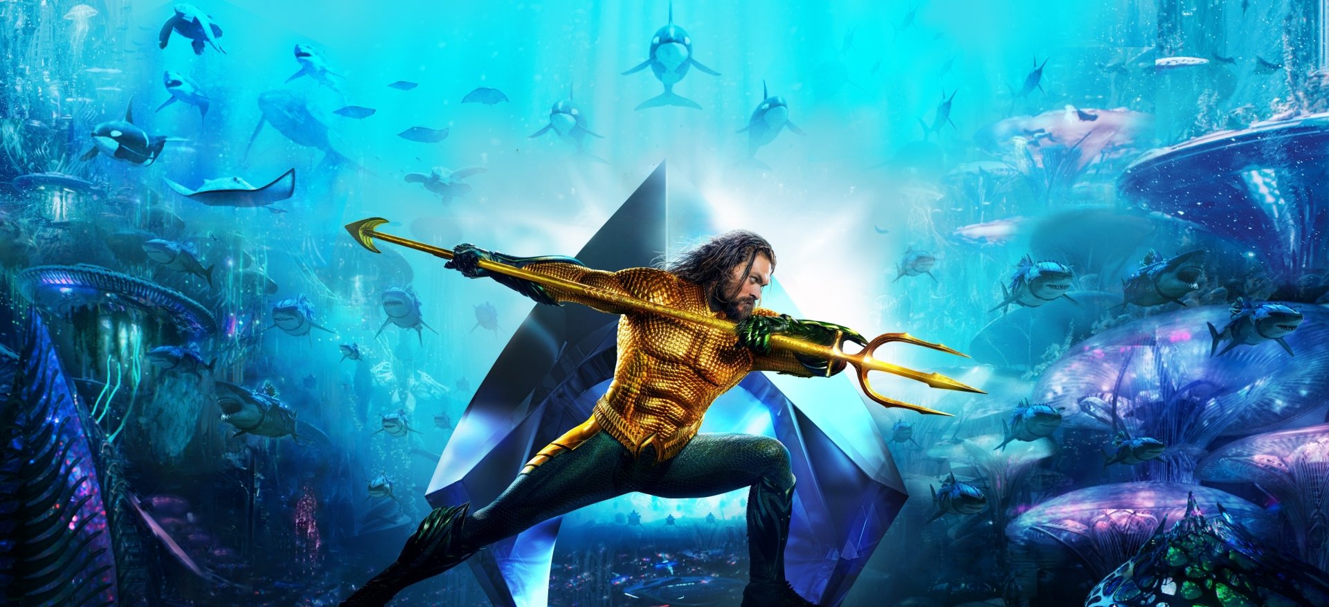 HD PC desktop wallpaper of Jason Momoa as Aquaman, wielding his trident underwater with sea creatures surrounding him in a dynamic movie-inspired scene.