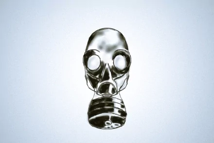 A dark HD wallpaper featuring a detailed gas mask against a light background, creating a striking contrast that enhances its mysterious and intense atmosphere.