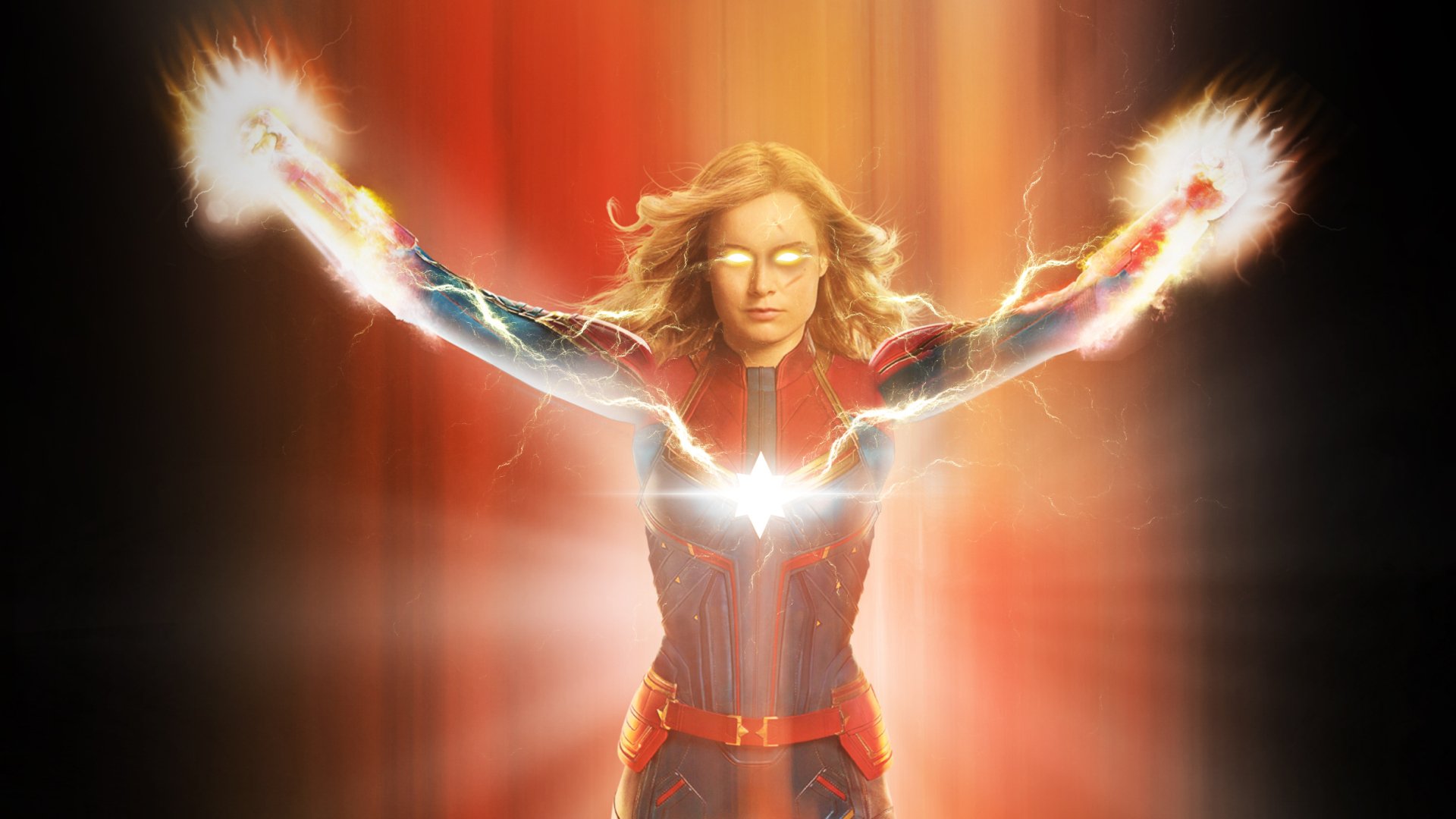 HD desktop wallpaper featuring Brie Larson as Captain Marvel, glowing with powerful energy and light effects in a dynamic pose from the movie.