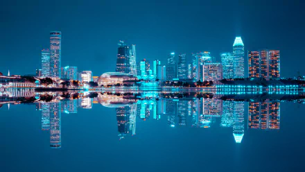 Alt Text: Nighttime cityscape of Singapore with illuminated buildings reflecting on water, captured in HD for a desktop wallpaper and background.