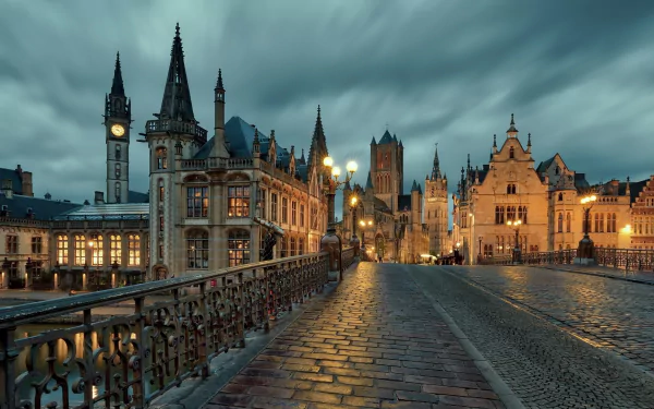 HD desktop wallpaper showcasing the historic man-made churches and gothic architecture of Ghent, Belgium, under a moody evening sky.