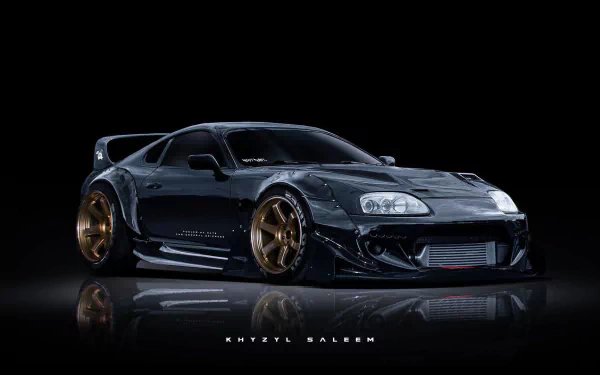 HD PC desktop wallpaper featuring a sleek, black Toyota Supra sports car with bronze wheels against a dark background.