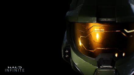 Halo Infinite video game HD PC desktop wallpaper: close-up of Master Chief's helmet with a glowing gold visor set against a black background, Halo Infinite logo at lower left.