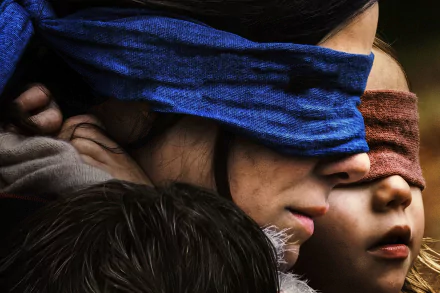 Close-up of Sandra Bullock and two children blindfolded, from the movie Bird Box, captured in 4K Ultra HD for a PC desktop wallpaper background.