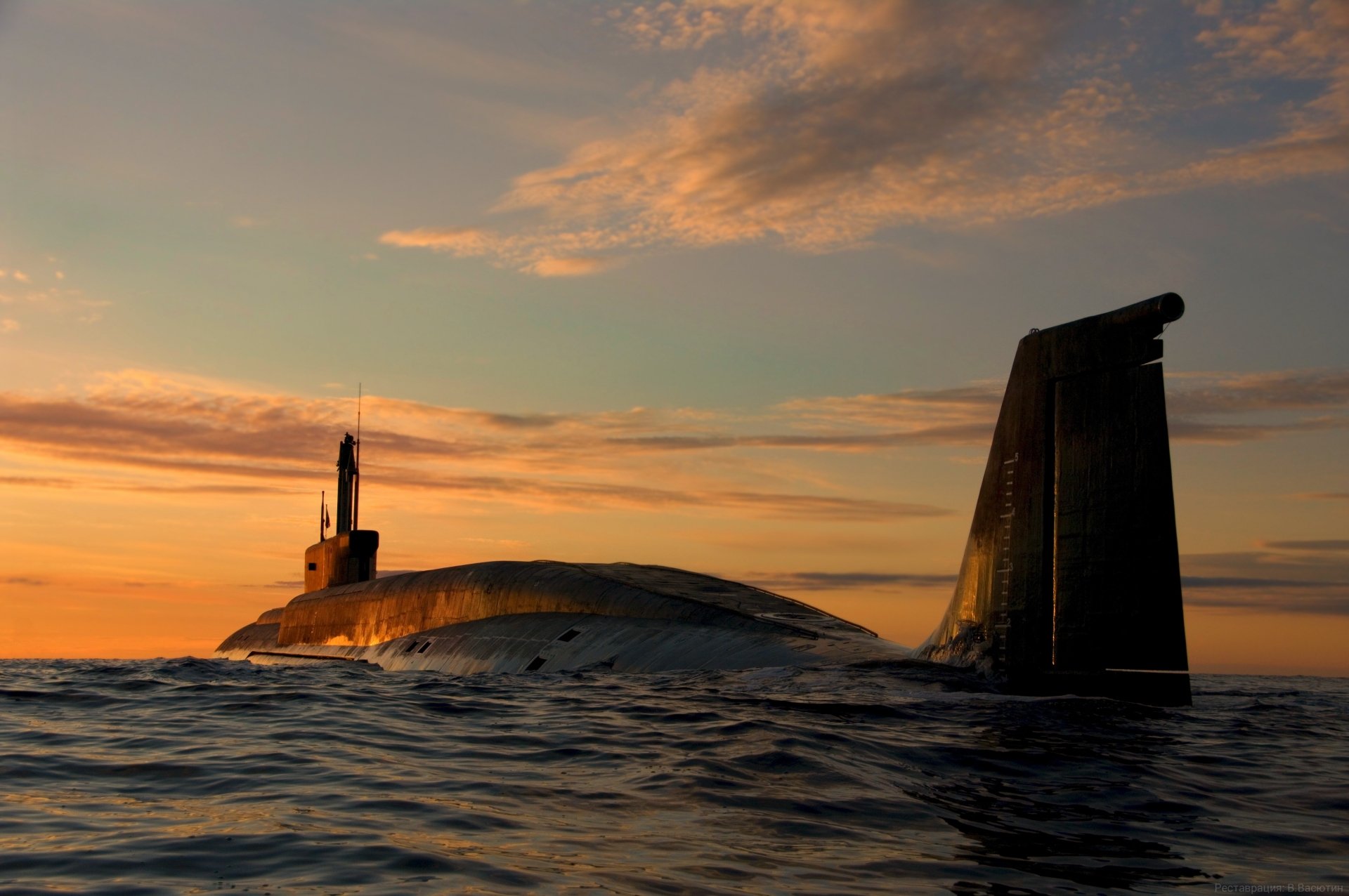 Military submarine at sunset on calm sea — 4K Ultra HD PC desktop wallpaper and background.