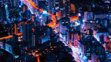 A vibrant night-time cityscape of Tokyo, Japan, captured with light trails in a time-lapse effect showcasing illuminated buildings and busy urban streets.