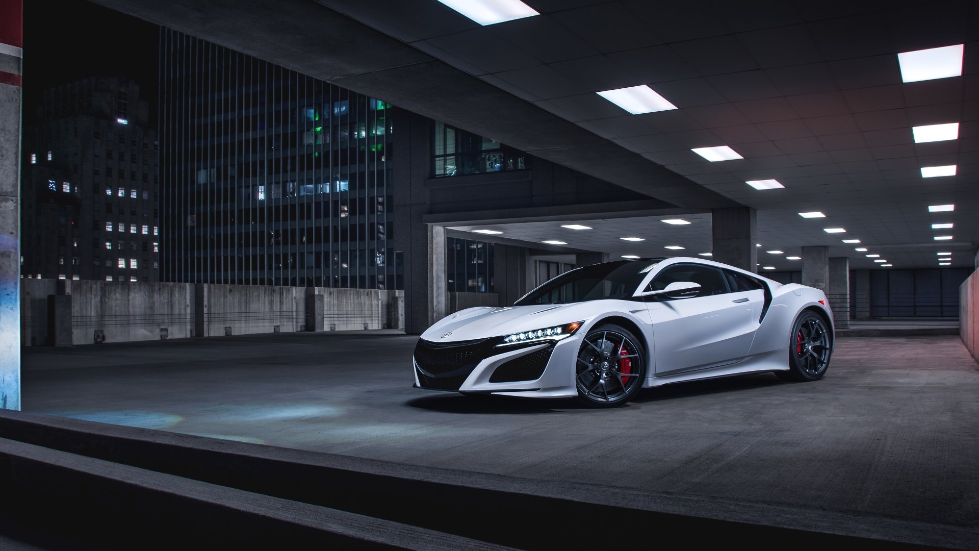 Sleek white Acura NSX supercar parked in an urban rooftop setting at night, showcased in sharp 4K Ultra HD resolution as a desktop wallpaper background.