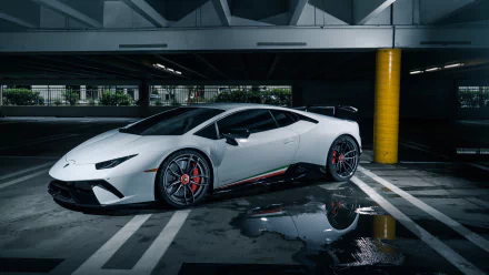 White Lamborghini Huracan Performante supercar parked in a dim, wet parking garage with reflections — 4K Ultra HD PC desktop wallpaper/background.