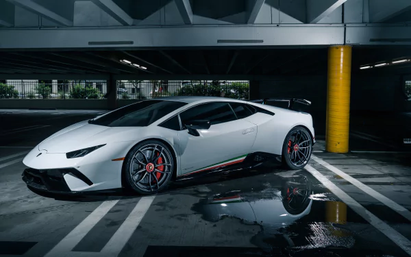 White Lamborghini Huracan Performante supercar parked in a dim, wet parking garage with reflections — 4K Ultra HD PC desktop wallpaper/background.