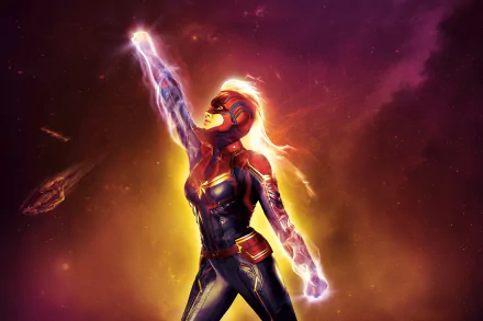 A vibrant HD wallpaper of Carol Danvers as Captain Marvel, portrayed by Brie Larson. She is shown in her superhero suit, emitting energy and soaring through space with a radiant background.