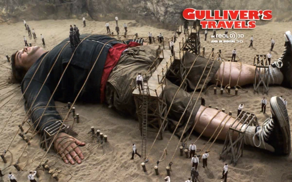 HD PC desktop wallpaper featuring a scene from the movie Gulliver's Travels, showing Gulliver tied down by tiny Lilliputians in a sandy landscape.