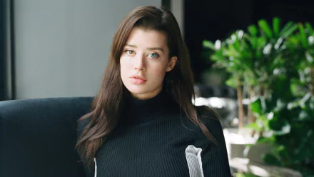 Portrait of brunette model Sarah McDaniel with heterochromia, wearing a black turtleneck, captured in high-resolution 4K for a PC desktop wallpaper.